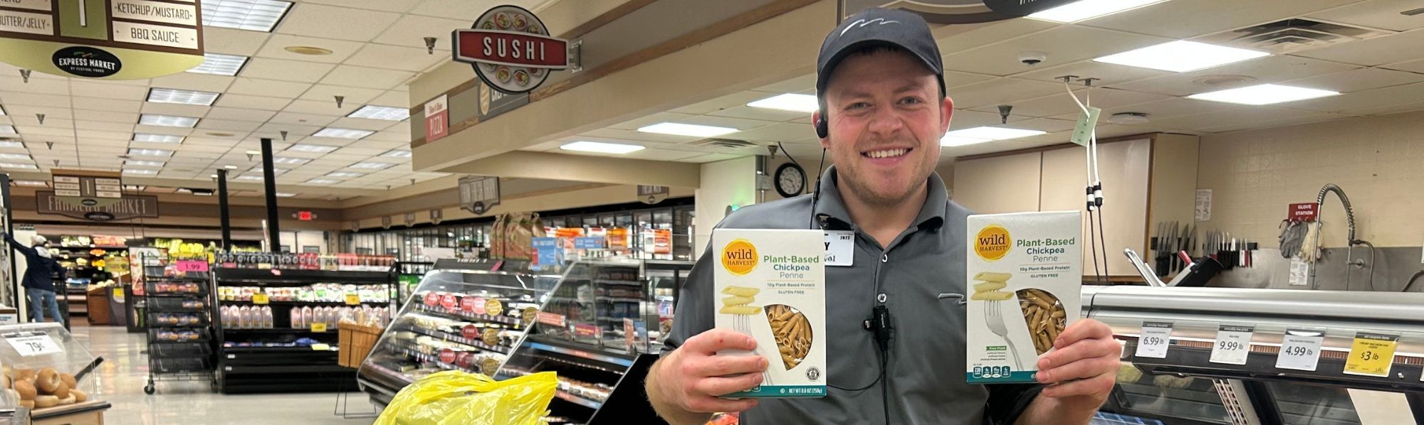 Man holding two boxes of pasta