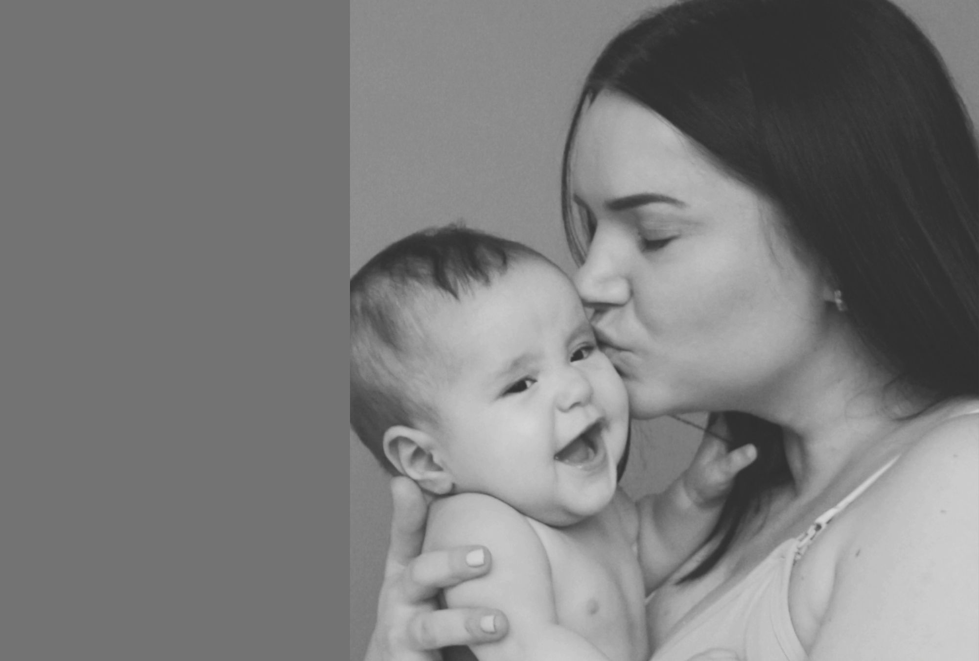 Mom kissing baby.