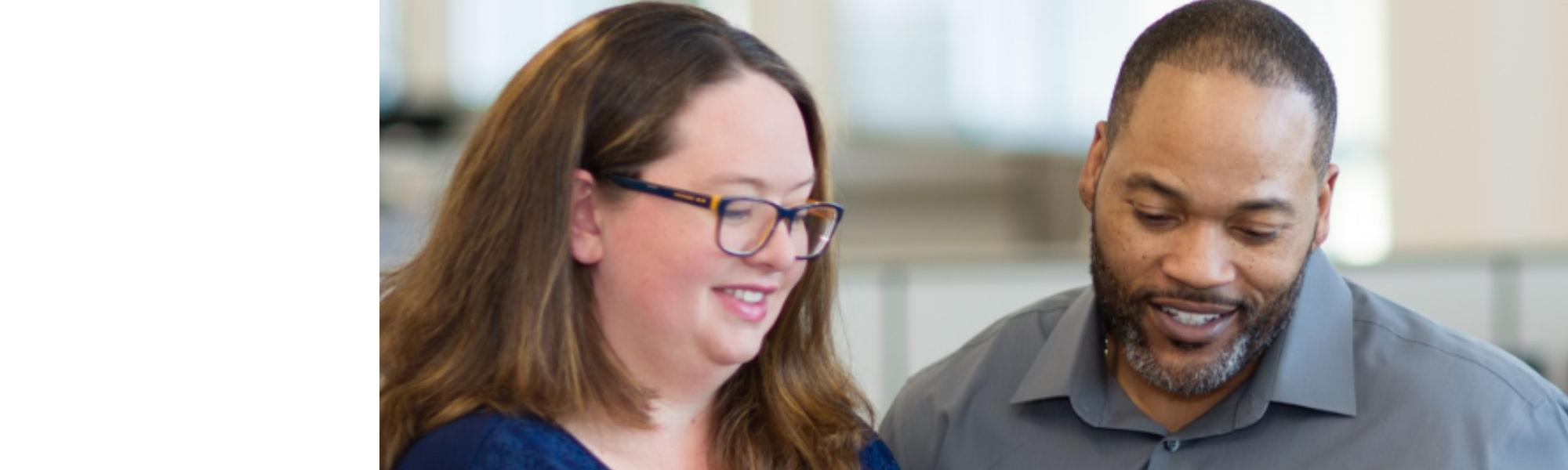 Man and woman looking at papers.