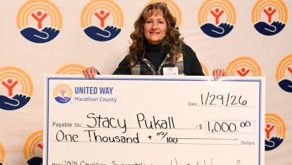 Woman holding big check for 1,000
